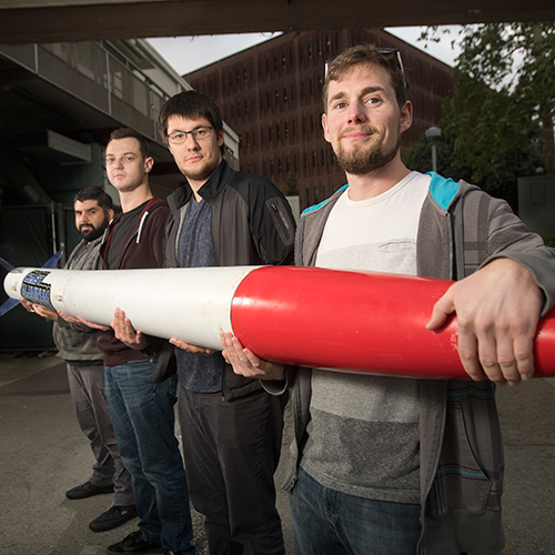 4 students hold a rocket