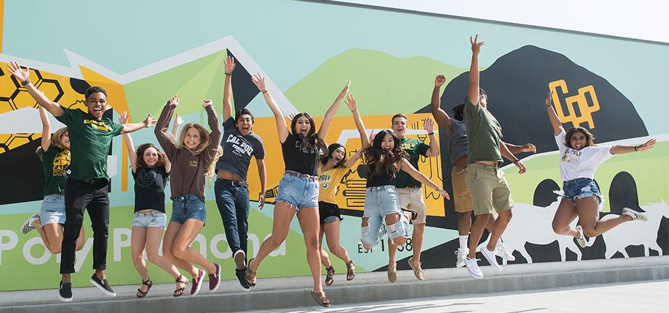 Students jumping in front of CPP mural. 