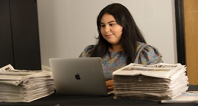 Female student works on her laptop