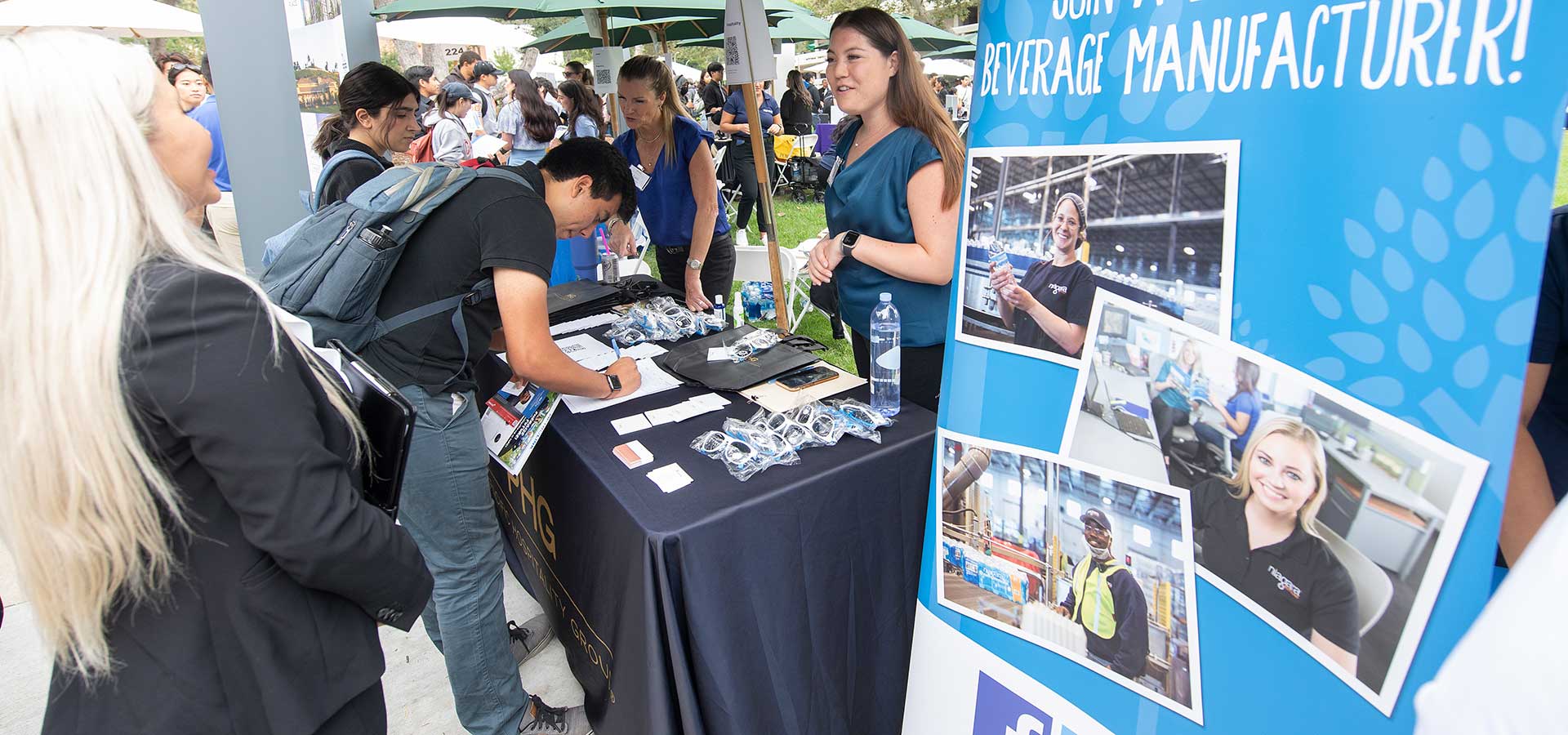 Students stop by the Niagara Bottling table at a career fair on campus. 