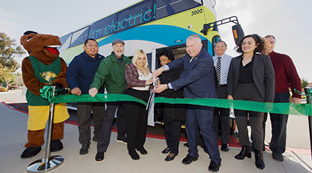 Billy Bronco, President Coley and other at the ribbon cutting of the Silver Streak bus.