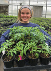 olivia carrying tray of plants